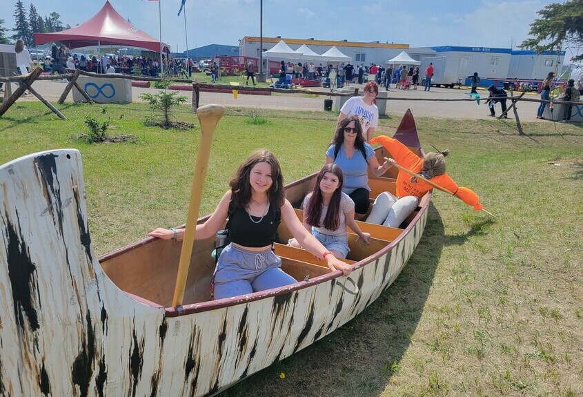Students sitting in a traditional canoe